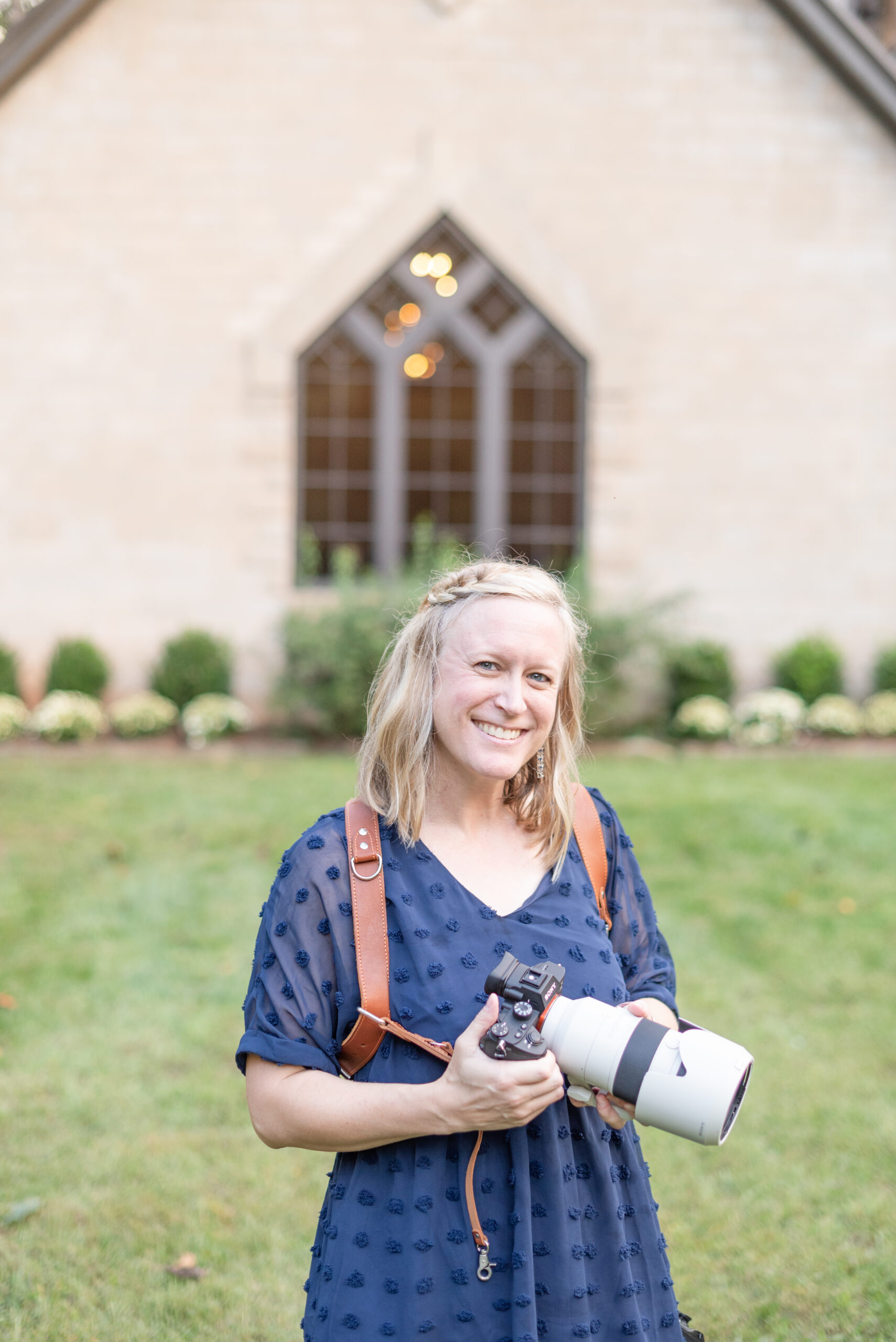 Greenville SC Wedding Photographer holding a Sony camera with a 70-200 mm lens